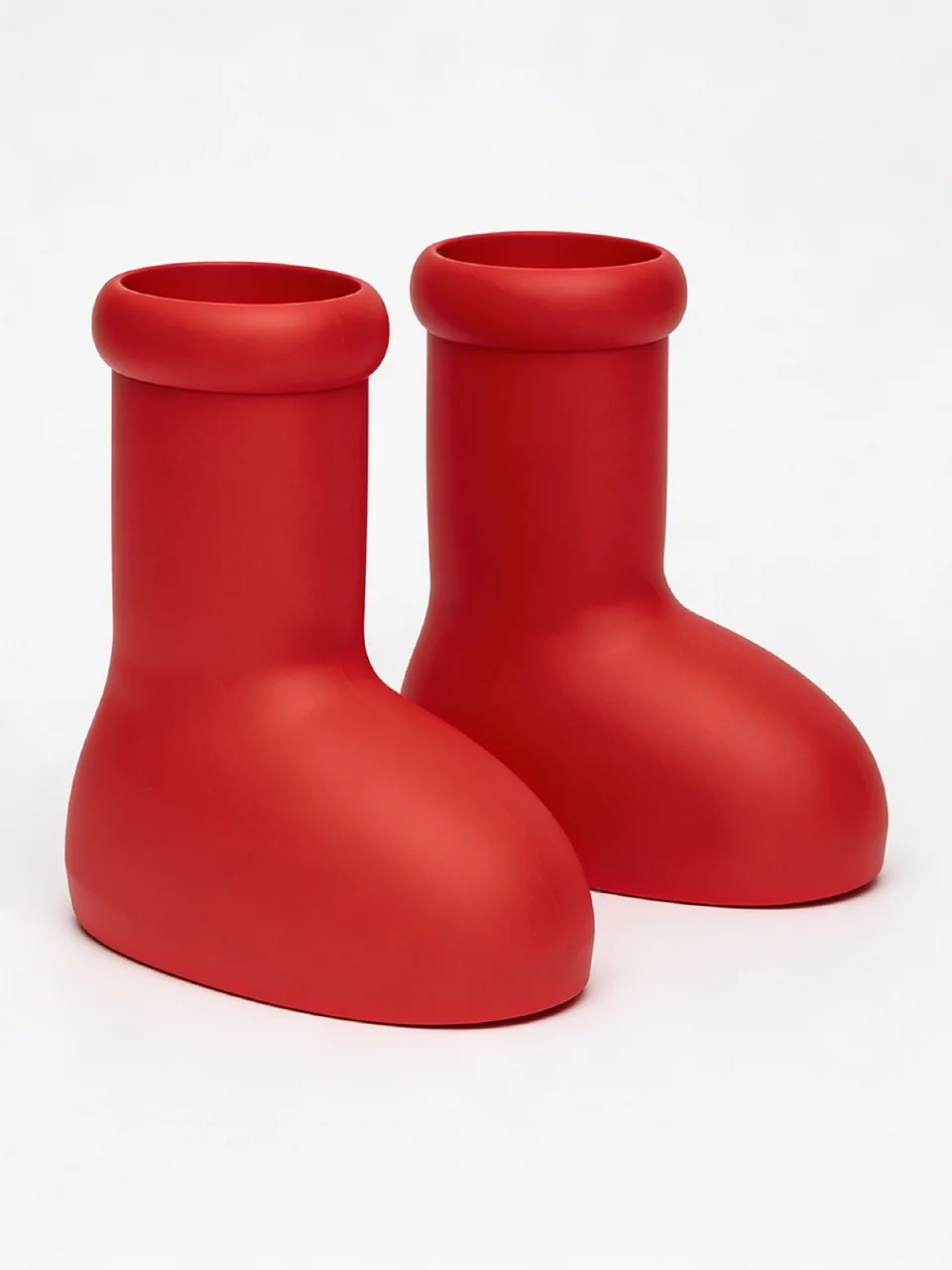 Seedream AI product shot of a pair of red rubber boots on a white background